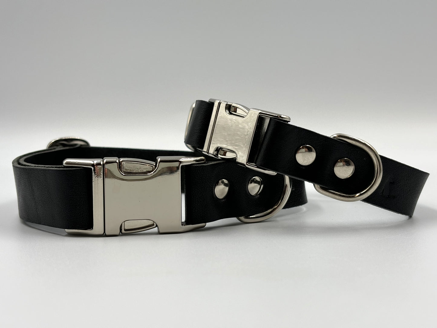 Luxury black leather dog collar with silver hardware, crafted from premium Italian leather, elegant design for discerning dogs.