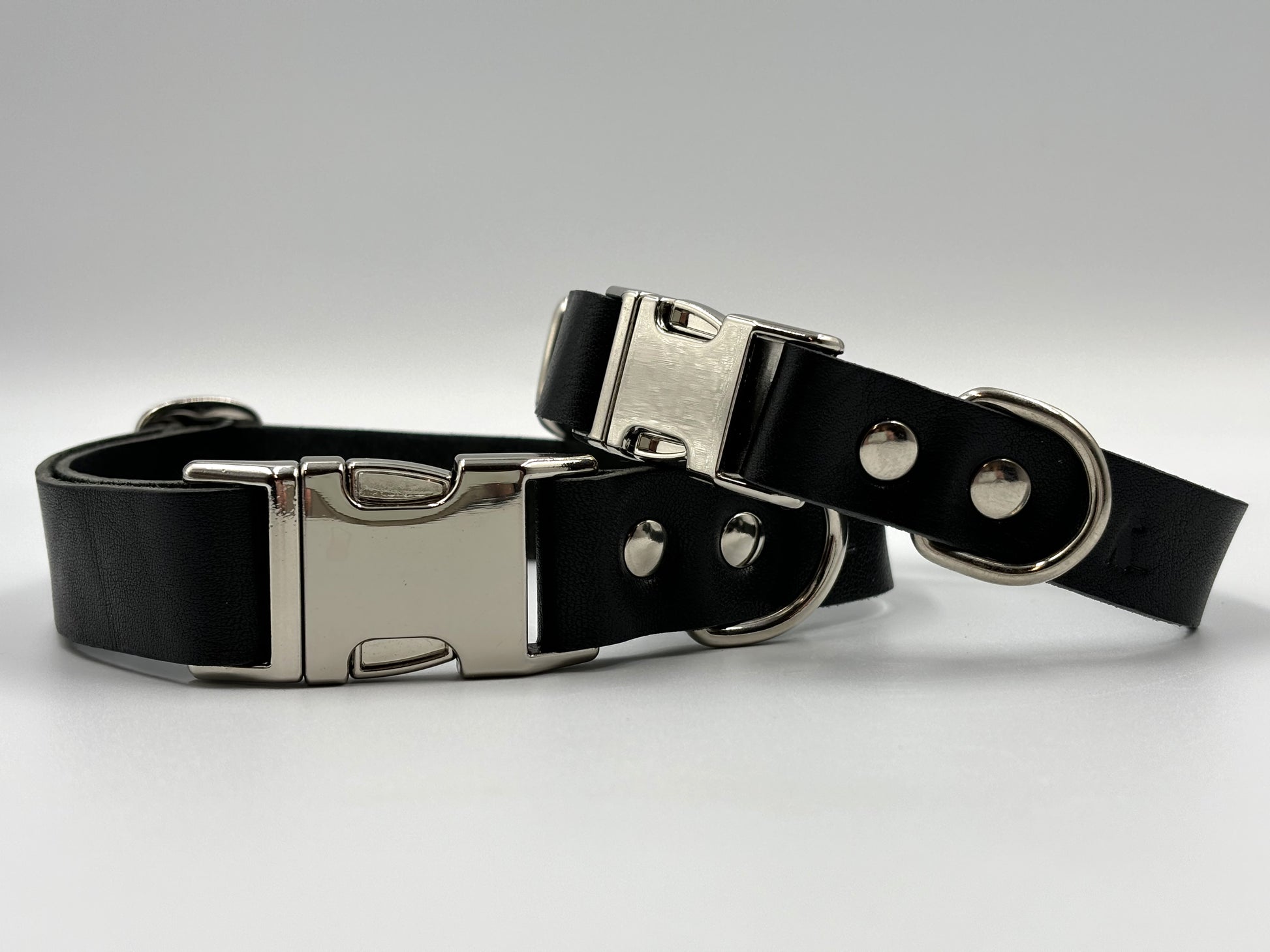 Luxury black leather dog collar with silver hardware, crafted from premium Italian leather, elegant design for discerning dogs.
